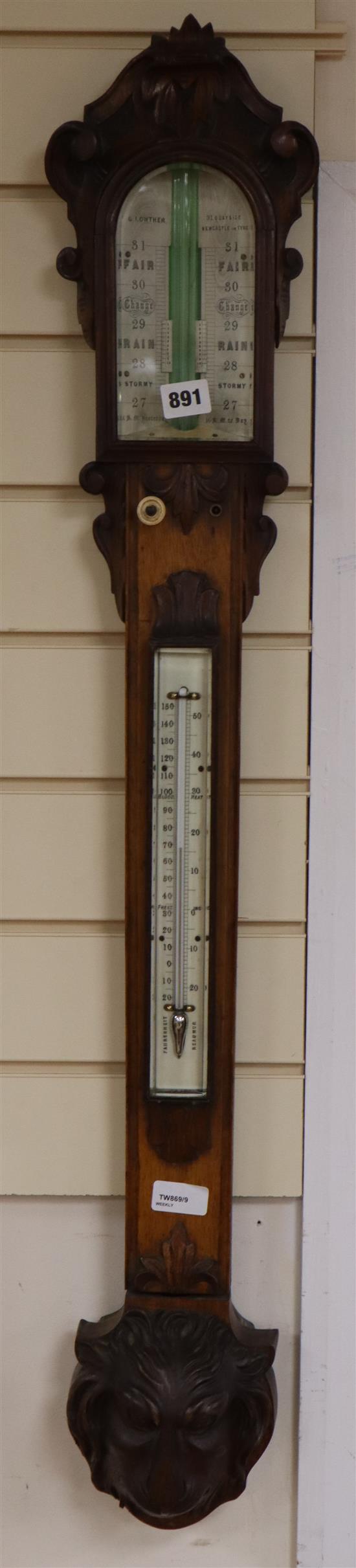 A Victorian carved oak stick barometer by G. I. Lowther, Newcastle on Tyne, in carved oak case with ivory scales and lions head reserv